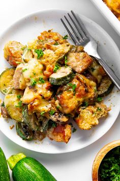 a white plate topped with zucchini and chicken