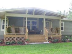 a small house with porches and steps leading to the front door