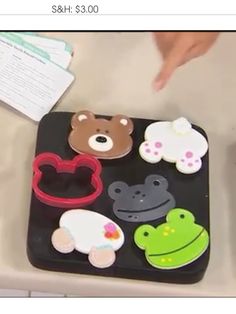 there is a tray that has various items on it and someone pointing at the object