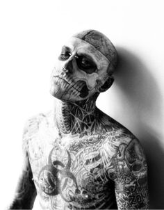 black and white photograph of a man with tattoos on his body