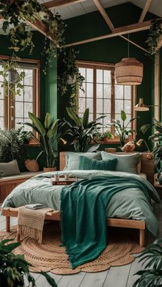 a bedroom with green walls and plants in the corner