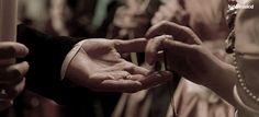 a man and woman holding hands while standing next to each other