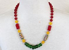 "This fun little necklace is simple, but the vibrant red, yellow, and green color combination packs a big punch!  Dress this necklace up or wear with jeans, it's a great necklace to take any outfit to the next level.     Materials: Green, Red, and Patterned Ghanaian Recycled Glass, Yellow Jade, Red Agate, Silver-Plated Spacers and Lobster Clasp  Length: Necklace: 21 1/2\" from end to end with 2\" extender chain  If you have any questions or concerns please feel free to contact me! ♥ ♥ ♥ ♥ ♥ ♥ ♥ New Necklace Designs, Rebecca Brown, Green Color Combinations, Necklace African, Wedding Red, Yellow Jade, Ethnic Necklaces, Red Agate, Glass Necklace