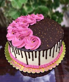 there is a chocolate cake with pink flowers on it