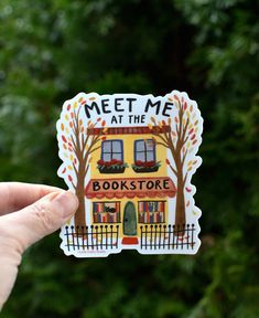 someone is holding up a sticker that says meet me at the bookstore