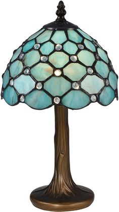 a lamp that is sitting on top of a wooden stand with a blue glass shade