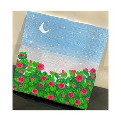 an acrylic painting of flowers and a moon in the sky on a canvas