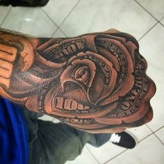 a man's arm with money tattoo on it and an eagle in the center