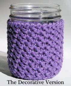 a purple crocheted jar cover sitting on top of a table