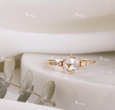 a white diamond ring sitting on top of a table