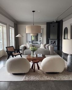 a living room filled with white furniture and lots of pillows on top of a rug