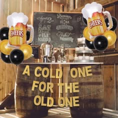 two beer mugs with balloons in front of a sign that says,'a cold one for the old one '