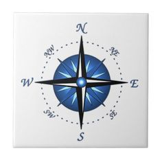 a blue and black compass on white tile