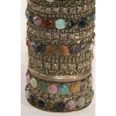 a stack of bracelets with different colored stones