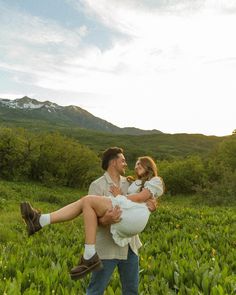 a man carrying a woman on his back in a field