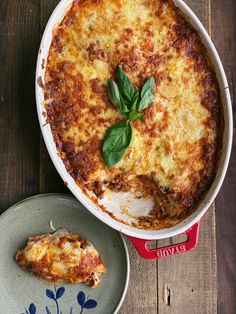 a casserole dish on a plate with a piece of pizza next to it