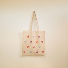 a bag hanging on the wall with hearts painted on it