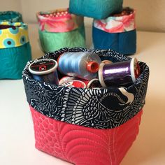 several different types of spools and thread in a bag on a table top