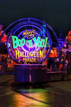 the entrance to mickey's boo - o - wee halloween parade is lit up at night