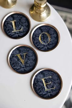 Lifestyle image of Set Of 4 Black & Gold Love Coasters on a white table, styled with other home accessories. Vintage Letterhead, Valentines Coasters, Glasses Of Wine, A Glass Of Wine, Instagram Tags, Wine Chiller, Glass Of Wine