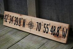 a wooden sign that says compass on it