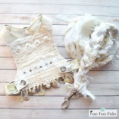 a pair of white garters on top of a wooden floor next to buttons