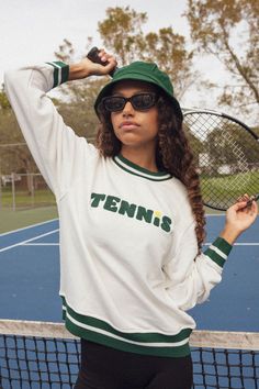 Serve up some looks in this adorable tennis sweatshirt!  Self: 100% Cotton Art:  Chenille - 100% Acrylic Lightweight french terry sweatshirt Elasticated neck, hem and cuffs Crewneck  Fit   True to size  Garment Care  Hand-wash | hang dry  Machine wash cold | hang-dry Sweater will shrink slightly if put in dryer We recommend hand washing the sweaters and hang drying.  Should you need to machine wash, please do so on cold and hang dry, they will shrink slightly if put in the dryer. Tennis Sweatshirt, Cotton Art, Independent Designers Fashion, Kid Names, Oversized Fits, French Terry, Cream Color, Tennis, Hand Wash