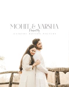 two people standing next to each other in front of a wooden fence with the words mohit and varsha written on it