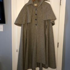 Vintage Women’s Grey Wool Cape With Capelet Sz S From James Holmes Apparel - Made By Sandy Cohen, Corona Ny Cape Has Shirt Type Collar And 4 Buttons Down Front. 2 Slits Shown Where Hands Would Come Through Cape. Caplet Is Detachable By 5 Buttons Under Collar. 100% Wool, Capelet Can Be Raised To Cover Your Head As Seen By In Old Movies! Very London/Little Woman 1800s Vibe. Front Length Collar To Hem 43” Back Length Collar To Hem 46” Back Collar To Caplet Hem 17” 1 Button On Front Missing. Fitted Fall Cape For Costume, Fitted Cape For Fall Costume, Vintage Fitted Cape Outerwear, 1800s Vibe, Sandy Cohen, James Holmes, Inverness Cape, Hooded Capelet, Wool Capelet