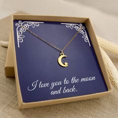 i love you to the moon and back necklace in a gift box on a table