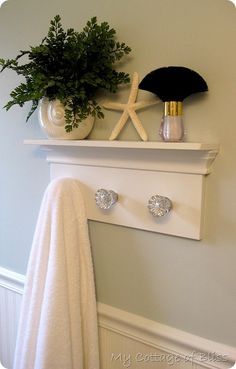 a towel rack with two towels and a potted plant