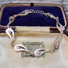 Elegant sterling silver  bracelet, it can be worn between 6.5" up to 7.2" long (15cm up to 18.5cm), fits small wrists A sleek row of teadrop shaped links, each 7mm wide, set with a sparkly pink zirconia Great for everyday wear Full UK hallmarks , in very good condition (I've not taken photos of the hallmark, please let me know if you want a separate photo for it) Weight 11gr All gemstones have been fully tested All silver has been fully verified Jewellery box is for presentation purposes only Sterling Silver Teardrop Bracelet As Gift, Formal Silver Teardrop Bracelets, Pink Topaz, Sterling Silver Bracelet, Chain Link Bracelet, Sterling Silver Bracelets, Arm Band, Chain Link, Topaz