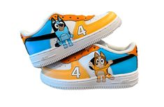 a pair of shoes with cartoon characters painted on the upper part of each shoe,