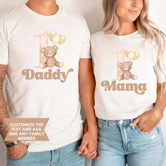 two people wearing matching tshirts with the number one and teddy bear on them