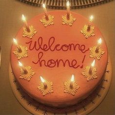 a cake with candles on it that says welcome home