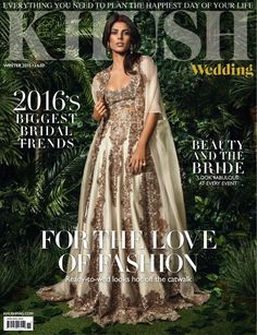 a magazine cover with a woman in a dress on the front and green foliage behind her