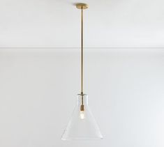 a clear glass pendant light hanging from a ceiling fixture in a room with white walls