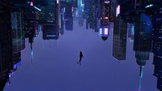 a man standing in the middle of a city at night with skyscrapers lit up