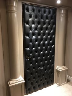 a large black leather door in the corner of a room