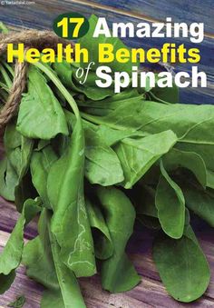 some spinach leaves on a wooden table with the title 17 amazing health benefits of spinach