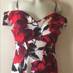 a red and white floral print dress on a mannequin