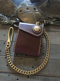 "\"The Rambler\" wallet is made 100% by hand out of the highest quality bridle leather, which is the same leather used to make saddles. It will hold up to the most rugged of use and develop a beautiful and unique patina over time. Features: - 4 1/4 inches long X 3 3/8 inches wide when closed - Cash slot - 2 card slots that can each fit multiple cards as well as a separate slot for an ID - Choose between a brass Indian or buffalo concho - Brass chain connector - It all stays shut via snap (CHAINS THAT ARE BOUGHT WITH A WALLET ARE 25% OFF REGULAR PRICE) - 1-2 week lead time - All wallets come with a lifetime guarantee PHOTO #5 shown with Thunderbird Charm and Tassel ADD ON. Sold separately." Chain Wallet Biker, Custom Wallets, Trucker Wallet, Wallet Chains, Biker Wallet, Reno Nv, Key Wallet, Chain Wallet, Slim Wallet