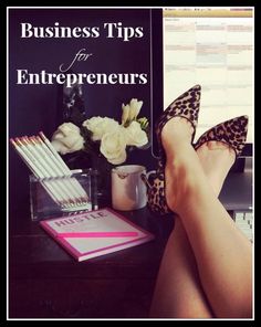 a woman's legs in high heels sitting next to a desk with flowers on it