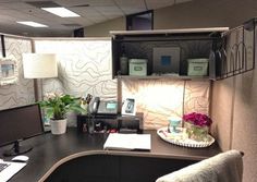 an office cubicle with a desk and computer