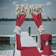 a red and white wedding set up on a dock