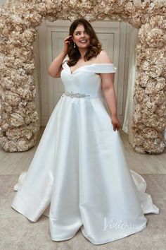 a woman in a white dress posing for the camera