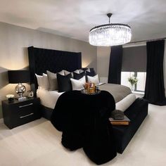 a black and white bedroom with a chandelier