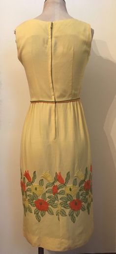 "Bright and beautiful yellow embroidered sleeveless dress from the 1960's is a figure hugging spring essential! Dress is made from a lightweight cotton/rayon and zips up the back with hook and eyes at the waistline and the back of the neck. Dress is in excellent vintage condition. Shoulders 14\" Chest 38\" Waist 25\" Hips 38\" Length from top of shoulder to hem 40\" Armhole 8\" Vintage garments have been previously worn and lovingly cared for, they may however have a blemish or two. Here at Made 1970s Style Yellow Spring Dress, Yellow Vintage A-line Dress For Spring, Yellow A-line Vintage Dress For Spring, Spring Yellow A-line Vintage Dress, Vintage Embroidered Sleeveless Dress, Vintage Sleeveless Embroidered Dress, 1950s Style Sleeveless Spring Vintage Dress, Retro Embroidered Summer Dress, Summer Retro Embroidered Dress