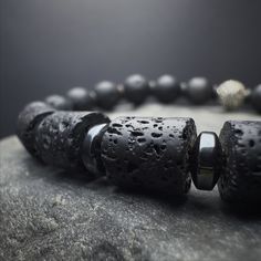 "Introducing our Men's Beaded Bracelet--a fusion of style and strength. Crafted with 8mm Lava stones, this minimalist bracelet seamlessly combines fashion and emotional balance. The stretch cord ensures a comfortable fit, while 925 sterling silver detail add a touch of sophistication to this versatile piece. Embrace the grounding energy of the Lava stone, making it more than just a fashion statement. This isn't just a men's silver bracelet; it's a symbol of resilience and style. Wear it as a roo Meditation Jewelry With Natural Lava Stones, Lava Stone Jewelry For Meditation With Natural Stones, Lava Stone Bracelets With Natural Stones For Gift, Meditation Bracelets With Natural Lava Stones, Gift Bracelets With Natural Lava Stones, Modern 8mm Beads Bracelet, Modern 8mm Bead Bracelet, Modern 8mm Beaded Bracelet, Round Lava Stone Beads Jewelry