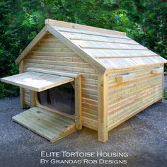 a dog house made out of wood with a ramp to the door and side entrance